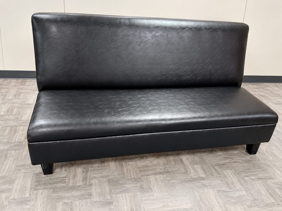 Black upholstered armless bench with a padded back and seat.