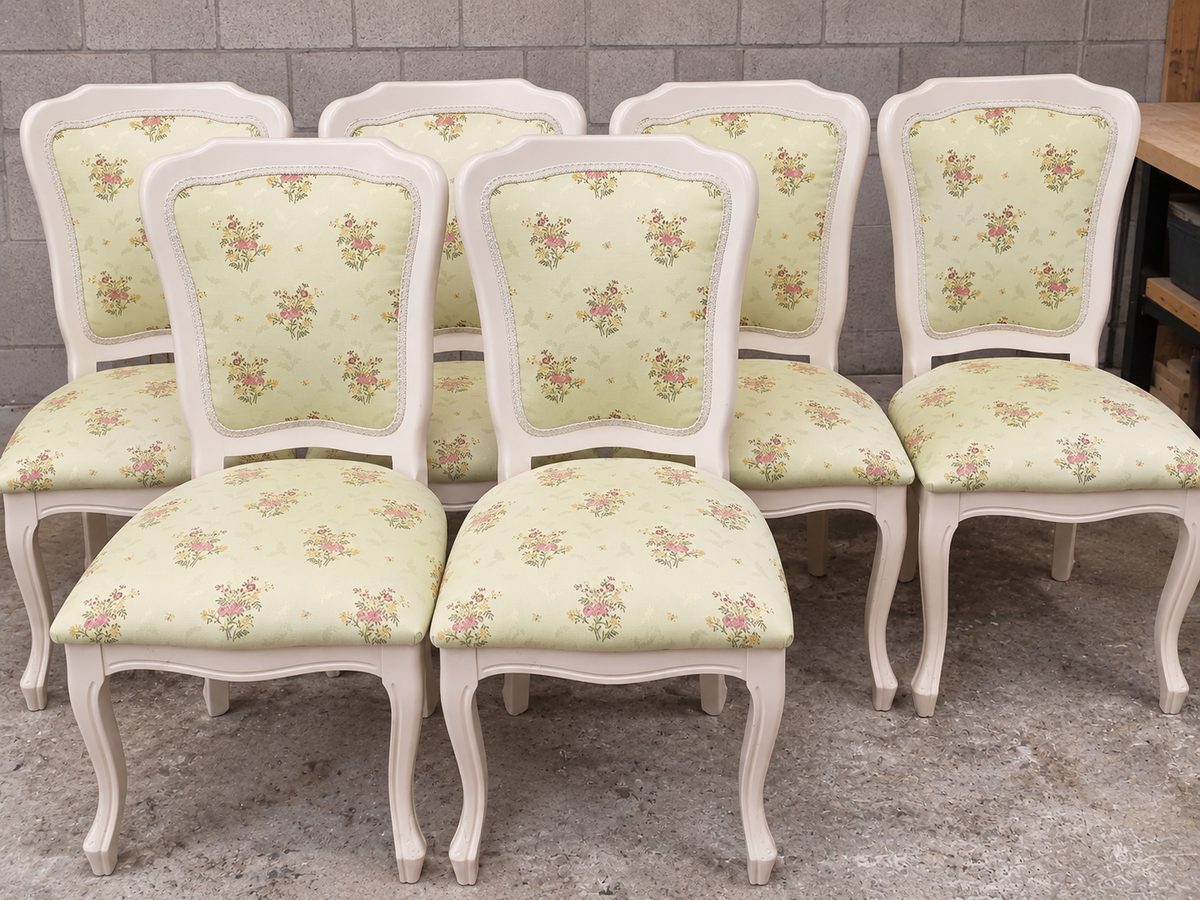 Cream dining chairs with floral upholstery on the seats and backs.