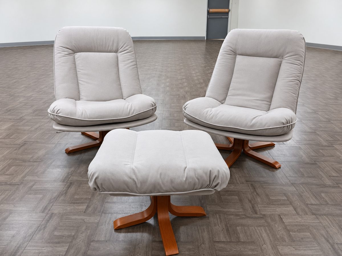 Front view of two light-gray upholstered recliners and an ottoman.