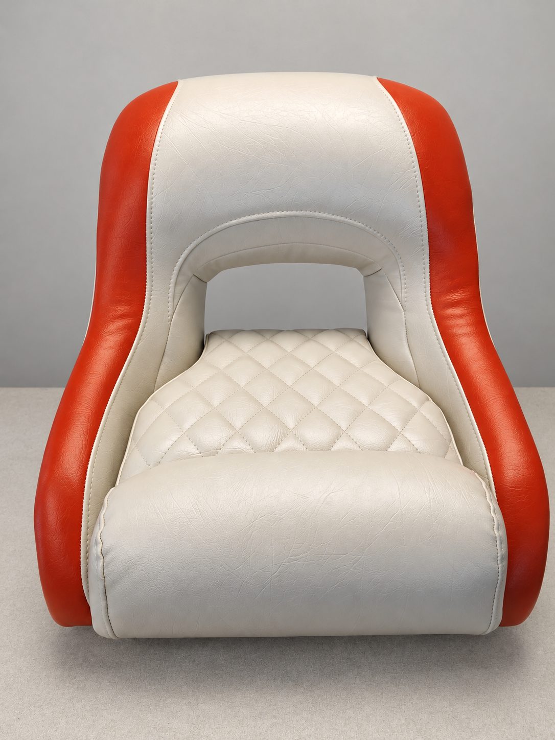 Orange and white boat bucket seat with a diamond-stitched cushion, photographed in the studio.