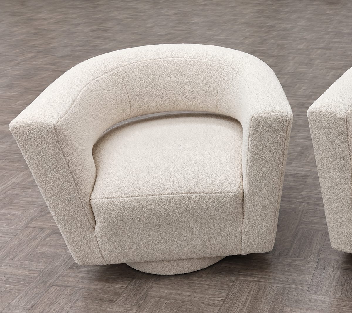 Close view of a white textured barrel chair.