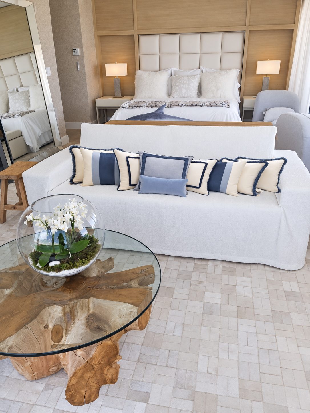 White sofa with blue-and-white decorative pillows.